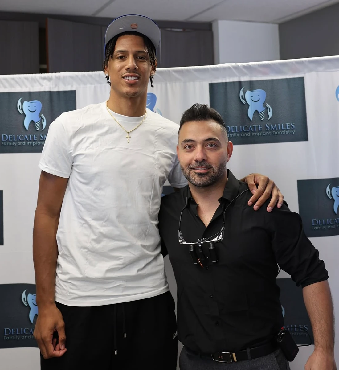 Delicate smiles milwaukee dentist with basketball player